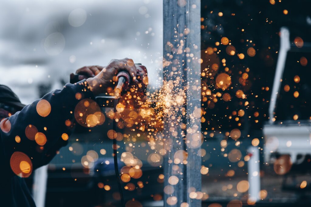 man welding metal with sparks flying